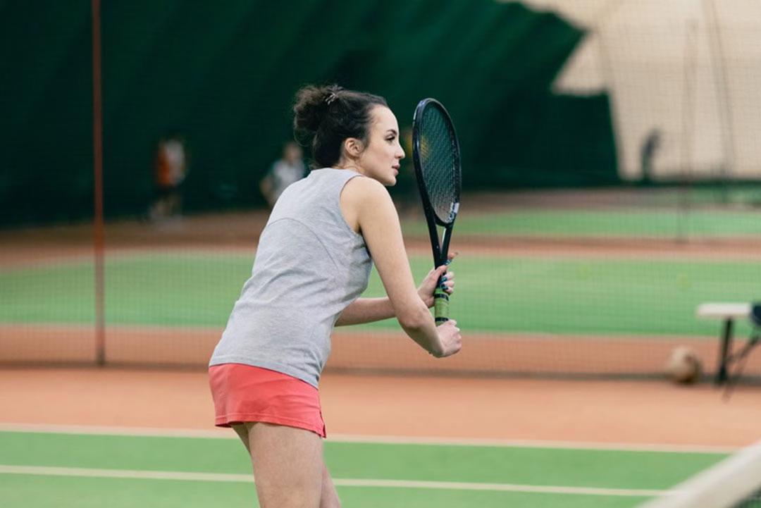 Eine Frau spielt Tennis in der Indoor-Tennishalle in St. Anton am Arlberg.