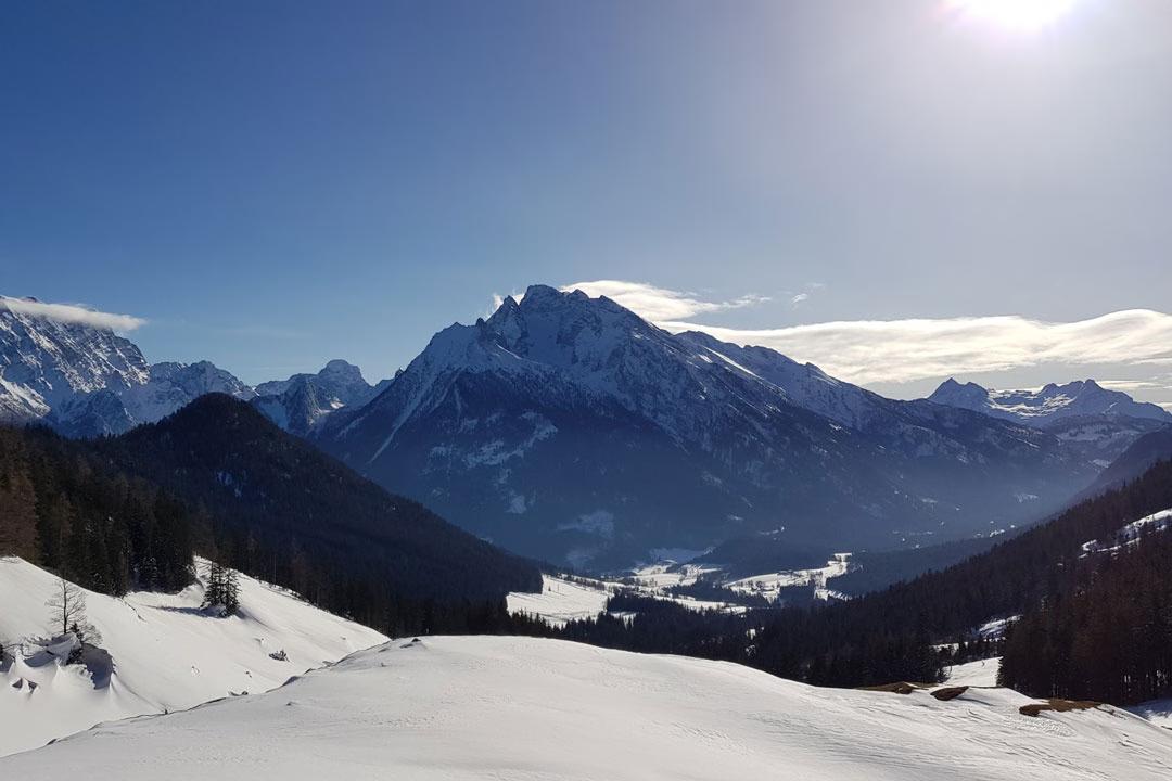 Schneeschuhwandern im Berchtesgadener Land mit weitem Blick auf verschneite Täler und Alpen.