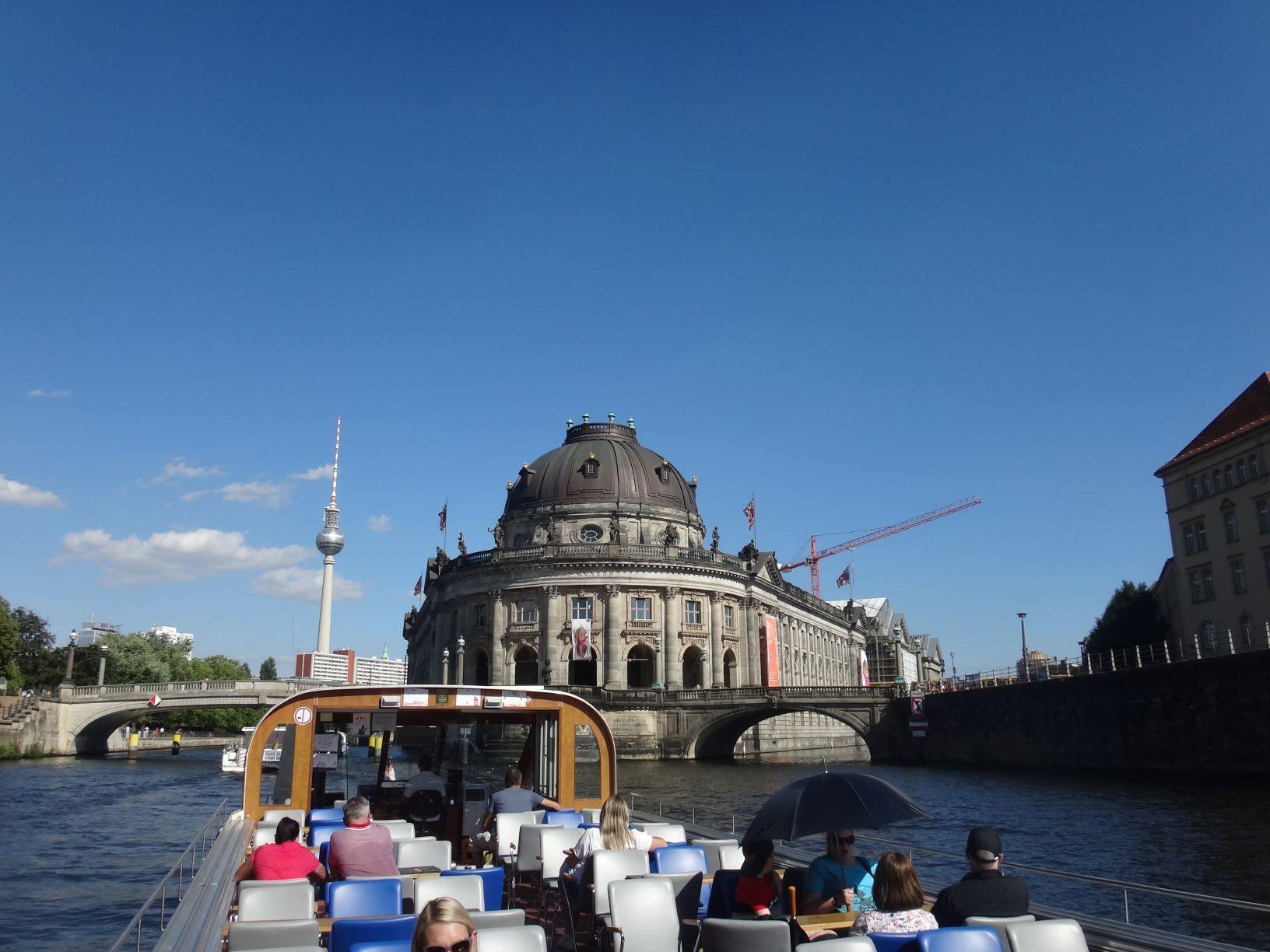 Personen auf einem Fahrgastschiff bei einer City-Tour auf der Spree durch Berlin