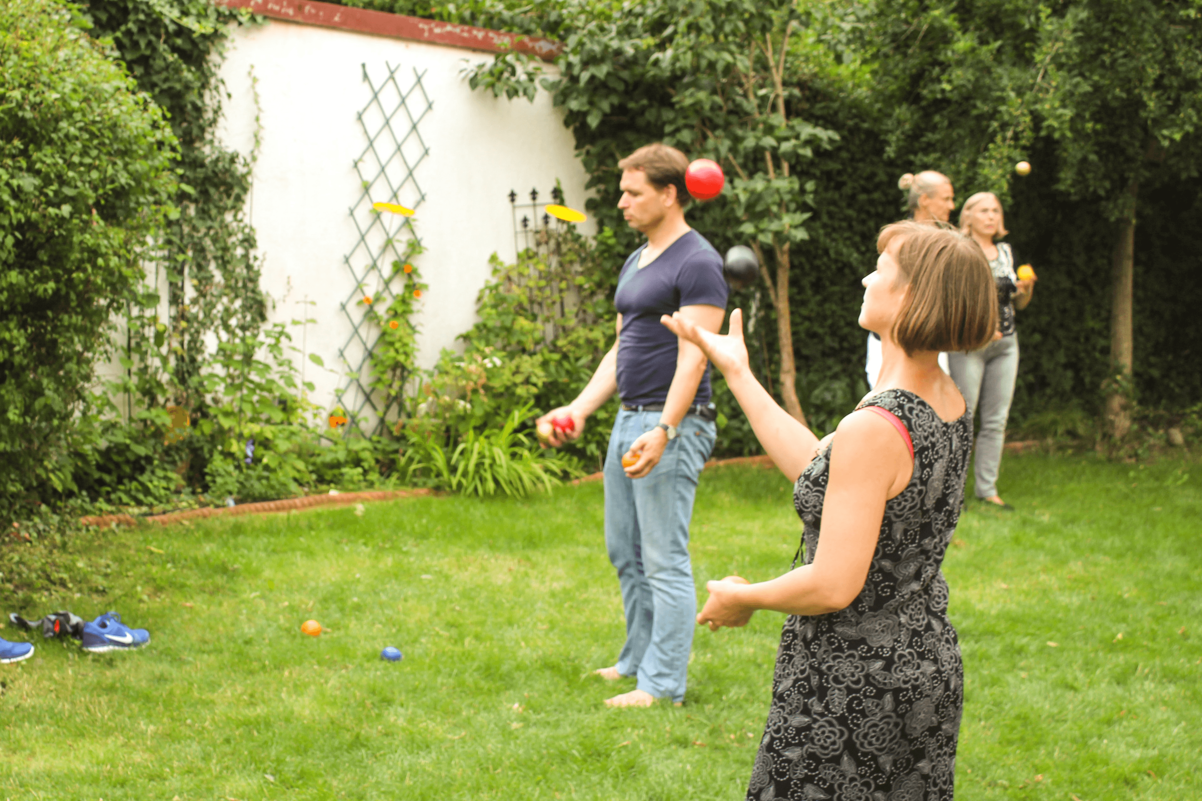 Teilnehmende eines Jonglier-Workshops werfen Bälle in die Höhe